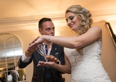 Jamie bending a wine glass in the brides hands!